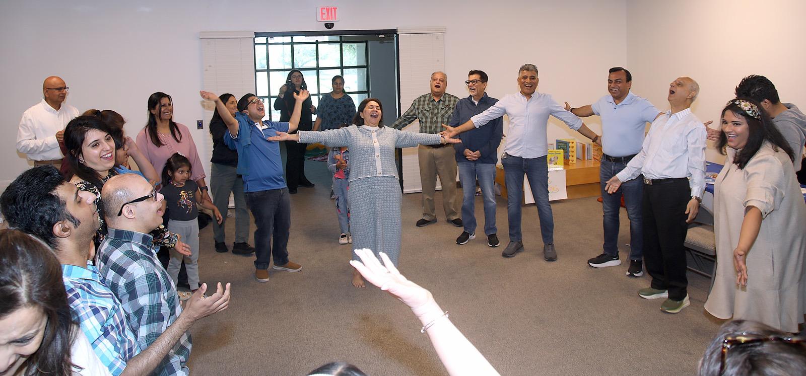 Suraiya leading a joyful laughter yoga circle in Dallas